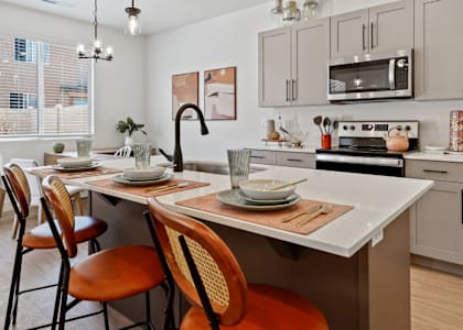 an open kitchen and dining area with a table and chairs