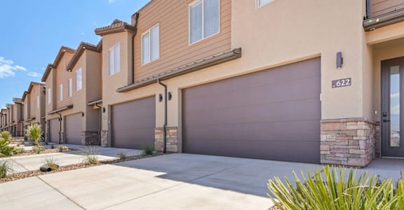 new homes with brown garage doors at the heritage at legacy