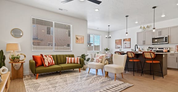 a living room with a couch and a kitchen with a table and chairs
