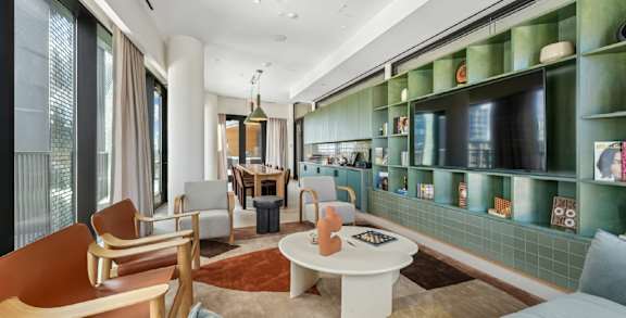 A living room with a white table and chairs.