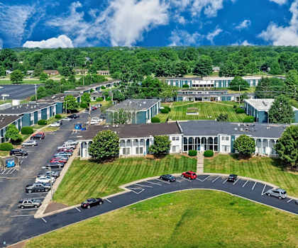A large building with a parking lot in front of it.