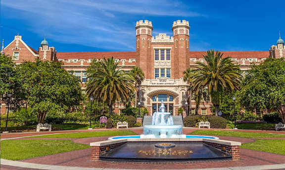 A large building with a fountain in front of it.