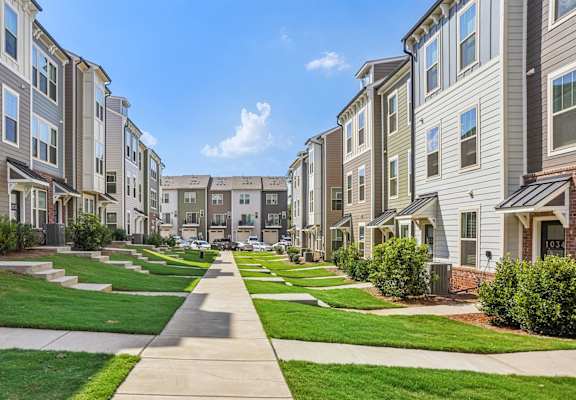 a row of town houses on a sidewalk
