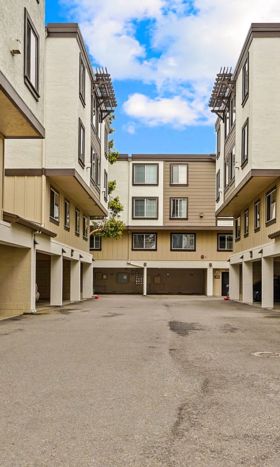 an empty parking lot in a large apartment building