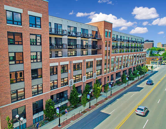 an aerial view of a large brick building on a city street