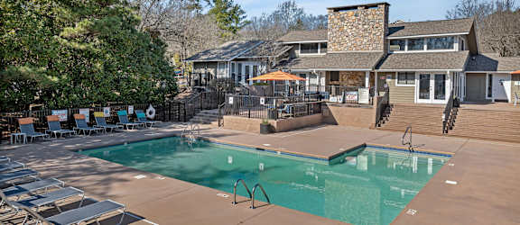 a swimming pool with a house in the background