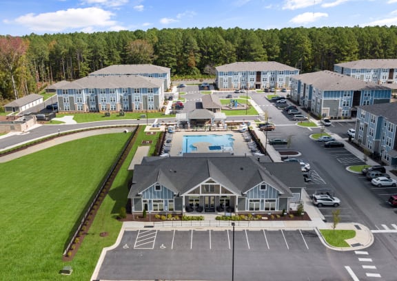 an aerial view of an apartment complex with a swimming pool