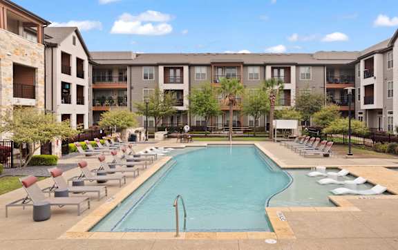 Axis Marketplace Apartments in Kyle, Texas Pool with Lounge Chairs