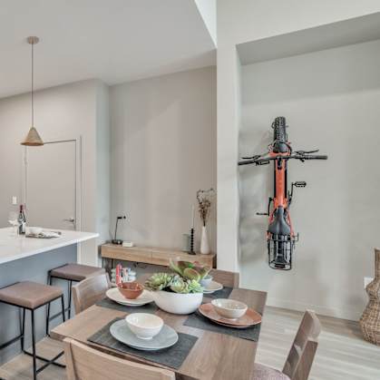 a kitchen and dining area with stainless steel appliances and a table with chairs