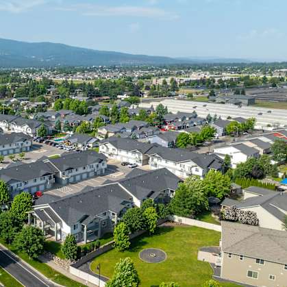 A suburban neighborhood with houses and a mountain in the distance.