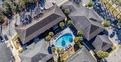 A bird's eye view of Mandarin Bay Apartments and a swimming pool.