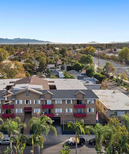 A residential area with apartment buildings and palm trees.