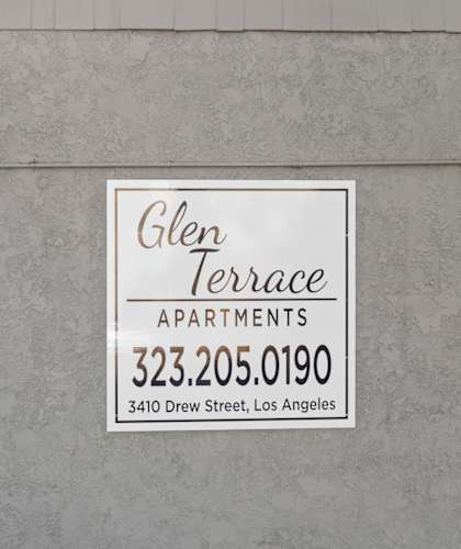 A sign for Glen Terrace Apartments is on a wall.