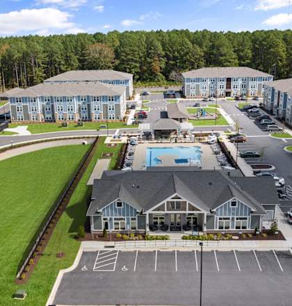 an aerial view of an apartment complex with a swimming pool