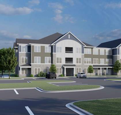 A rendering of a modern apartment complex with cars parked in the driveway.
