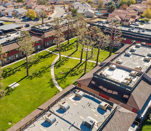 A bird's eye view of a residential area with houses and trees.