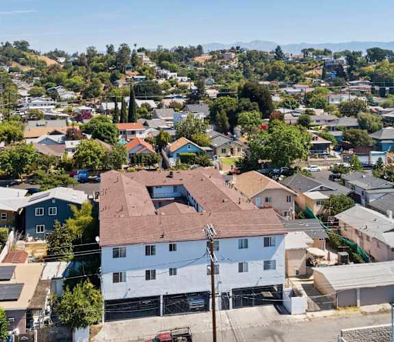 A bird's eye view of a residential area with houses and trees.