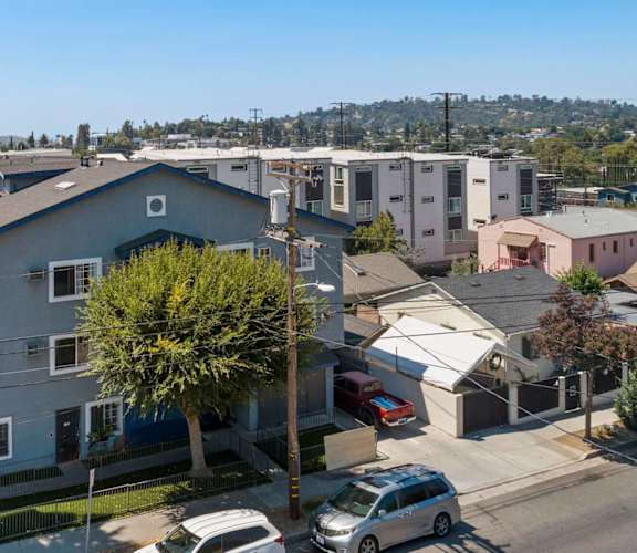 A residential area with houses and parked cars.