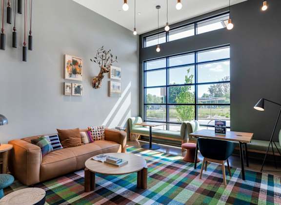 a living room with a couch and a table and a large window
