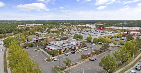 an aerial view of the parking lot of a shopping center in a city