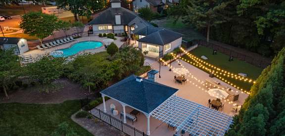 an aerial view of a pool and patio area at night