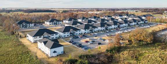 an aerial view of a group of houses in a parking lot