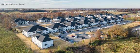 an aerial view of a group of houses and a parking lot