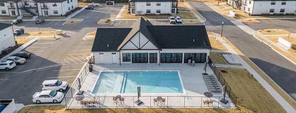 an aerial view of a building with a swimming pool