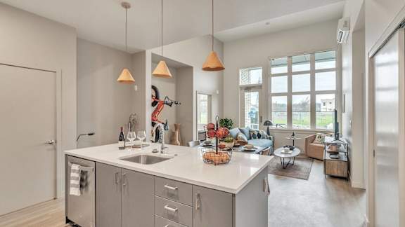 a kitchen with an island and a living room with a couch