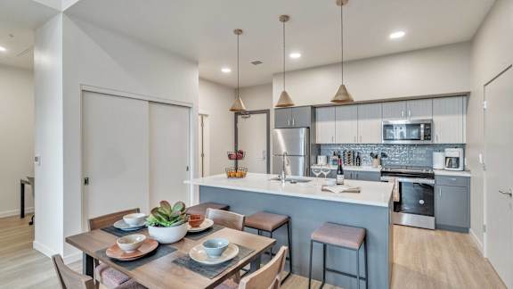 an open kitchen and dining room with a table and chairs