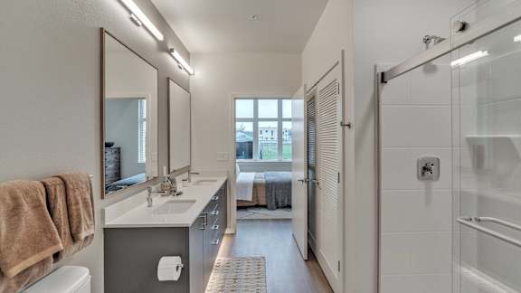 a bathroom with a shower and a sink and a mirror