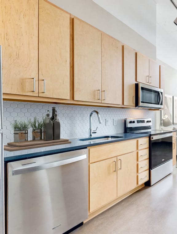 a kitchen with wooden cabinets and stainless steel appliances and a counter top