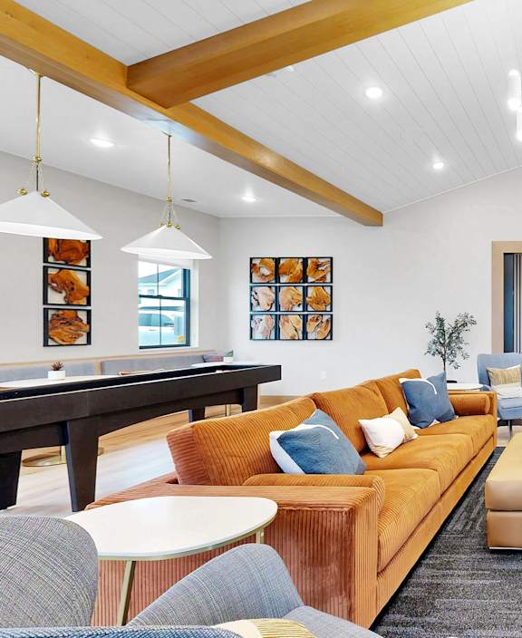a covered patio with furniture and a fireplace at Sandhill Parkway Townhomes Apartments, East Bethel, Minnesota