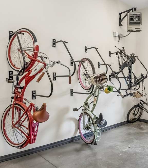 A gym with a variety of exercise equipment including treadmills, stationary bikes, and weight machines.