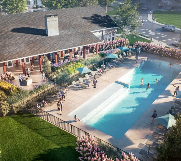 an aerial view of a pool and a building with people in it