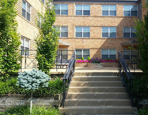 a staircase in front of a brick apartment building