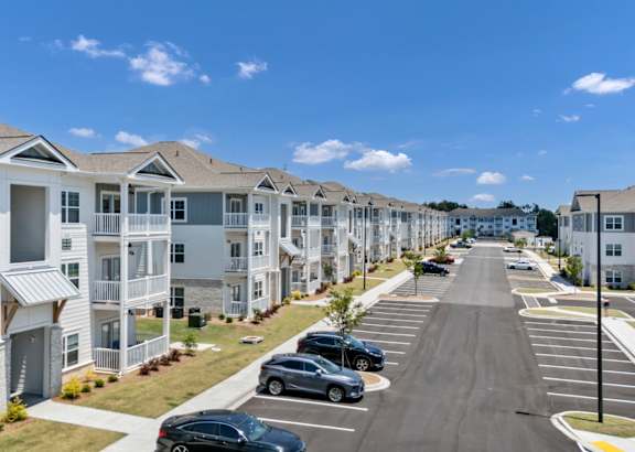 A white house with a black car parked in front.at The Landings at Hard Scrabble, South Carolina, 29203