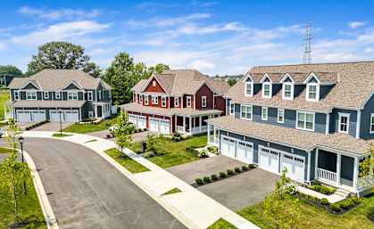 A row of houses with a cell tower in the background.