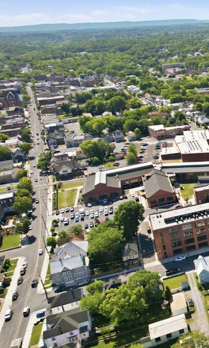 An aerial view of a town with a large building in the center.
