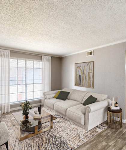 the living room of an apartment with a couch and chairs