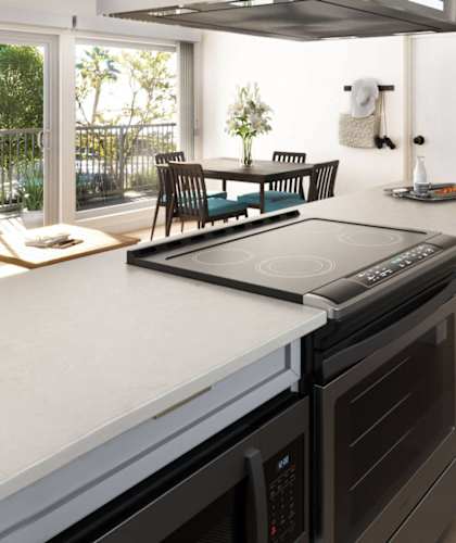 A modern kitchen with a large island and stainless steel appliances at Ocean Edge @ Laguna Beach Apartments, California