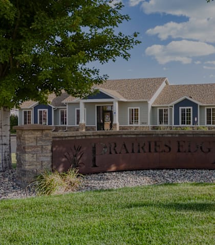 A sign that says "Raíres Edge" in front of a house.