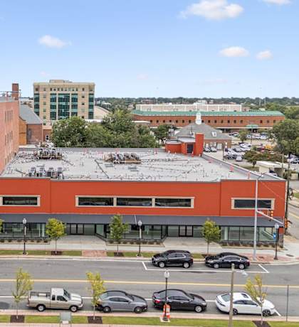 A parking lot with cars and a building in the background.