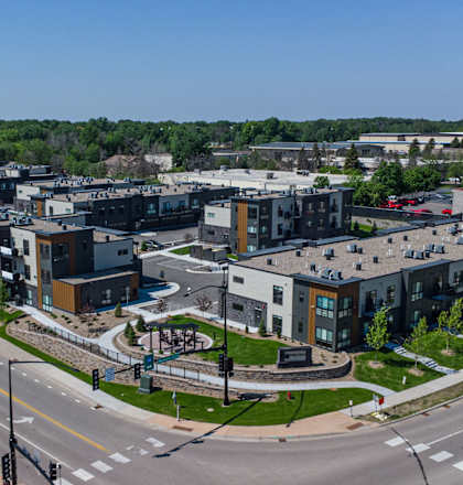 an aerial view of a cluster of buildings on a city street