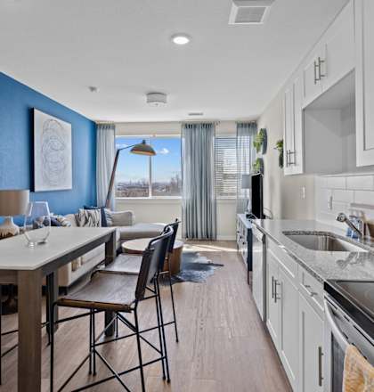 A modern kitchen with a dining table and chairs.