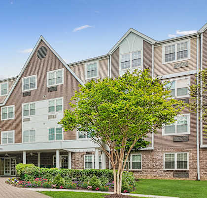 A large apartment complex with a landscaped front yard.