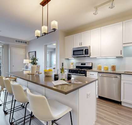 a kitchen with white cabinets and a counter top