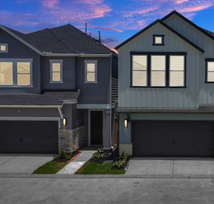 a home with a gray exterior and a black garage door