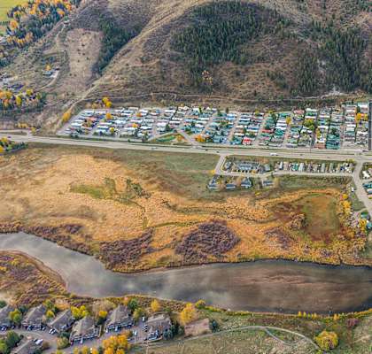 A bird's eye view of a residential area with houses and a river.