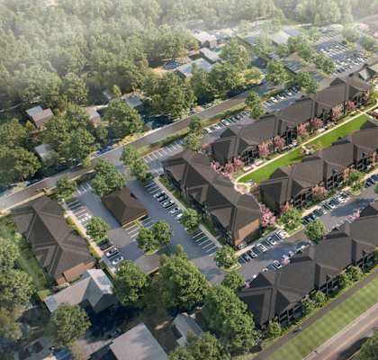 A bird's eye view of a residential area with houses and greenery.